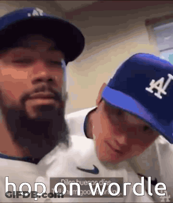 Two Men Wearing La Hats GIF