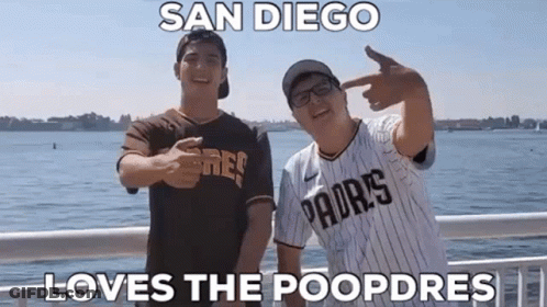 Two Men Wearing Padres Jerseys Are Standing Next To Each Other On A Bridge . GIF