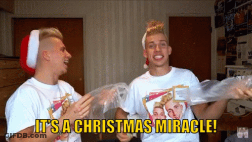 Two Men Wearing Santa Hats Are Holding Plastic Bags And Saying It Is A Christmas Miracle GIF