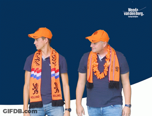 Two Men Wearing Scarves That Say Holland Are Walking GIF