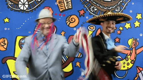 Two Men Wearing Sombrero Hats Are Dancing In Front Of A Mural That Says ' Fiesta ' GIF
