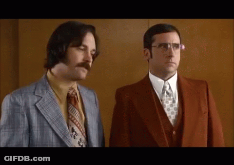 Two Men Wearing Suits And Ties Are Standing Next To Each Other . GIF