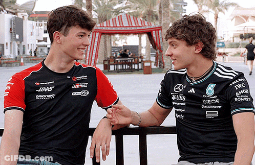 Two Men Wearing UBS Shirts Talking GIF