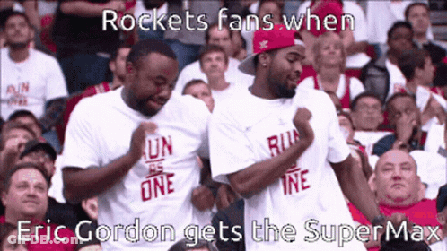 Two Men Wearing White Shirts That Say Run One Are Dancing In A Crowd GIF