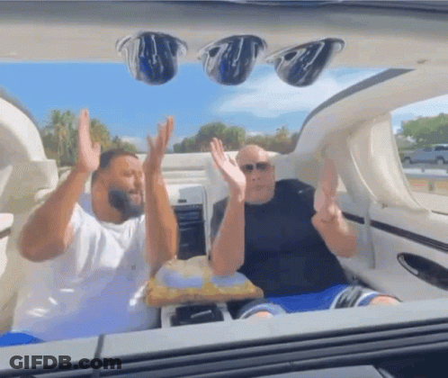 Two Men With Arms Up In Boat GIF