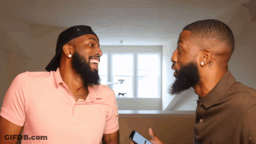 Two Men With Beards Are Laughing And One Is Holding A Cell Phone In His Hand GIF