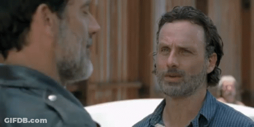Two Men With Beards Are Talking To Each Other In Front Of A Building . GIF