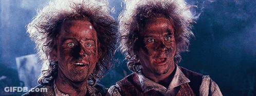 Two Men With Dirty Faces In Dark Room GIF