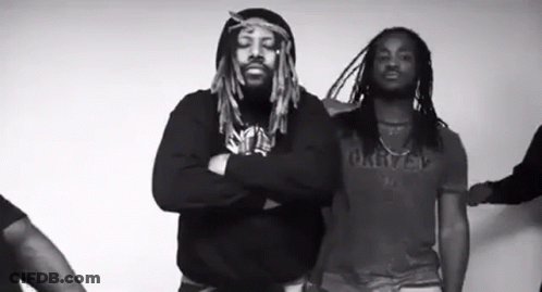 Two Men With Dreadlocks Standing With Arms Crossed GIF