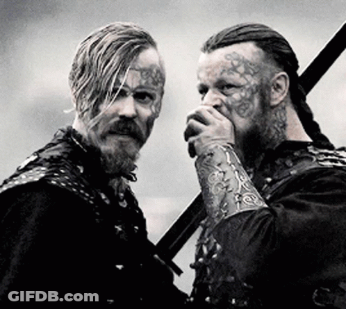 Two Men With Face Tattoos Holding Swords GIF