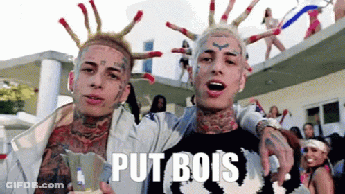 Two Men With Face Tattoos One Wearing Put B Shirt GIF