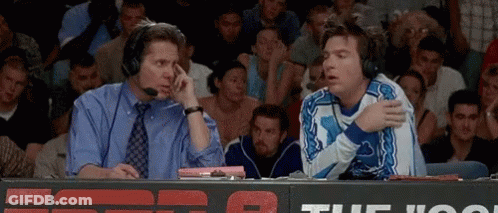Two Men With Headphones Talking In Stadium GIF