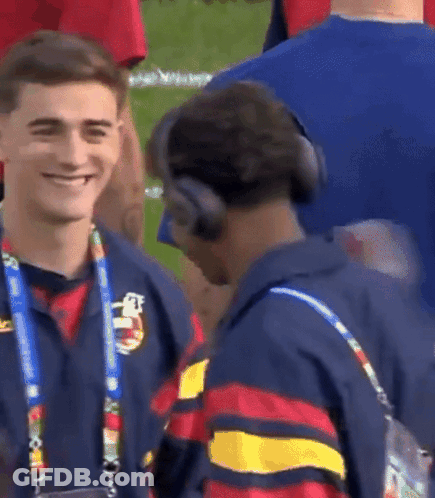 Two Men With Headphones Talking On Field GIF