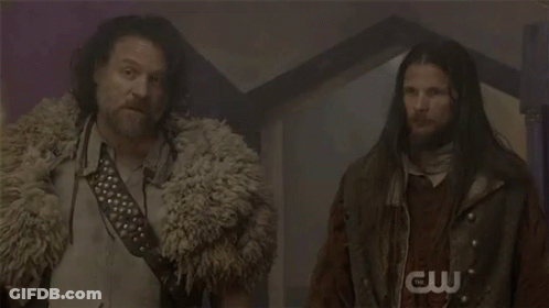 Two Men With Long Hair And Beard In Dark Room GIF