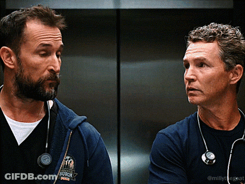 Two Men With Stethoscopes One Wearing Burgh Shirt GIF