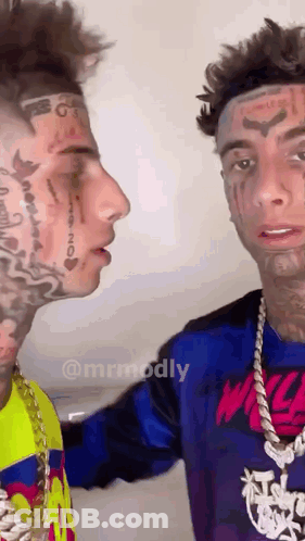 Two Men With Tattooed Faces Looking At Each Other GIF