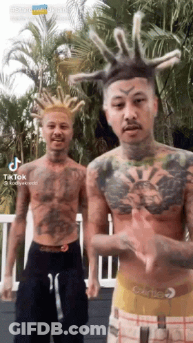 Two Men With Tattoos And Dreadlocks By Palm Tree GIF