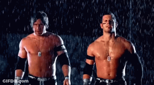 Two Men Without Shirts Are Standing In The Rain . GIF