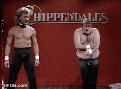 Two Men Without Shirts Are Standing Next To Each Other On A Stage In Front Of A Red Wall . GIF