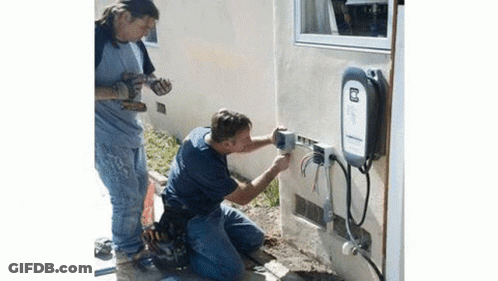 Two Men Working On Electrical Box GIF