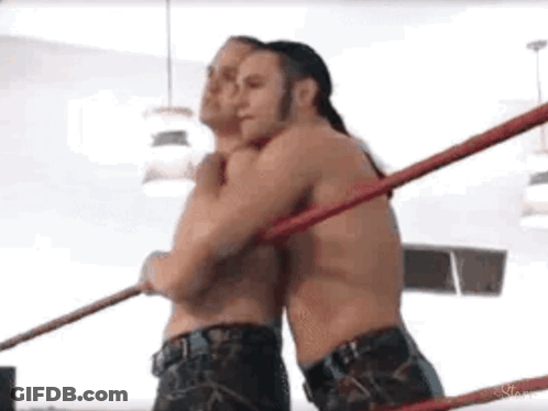 Two Men Wrestling And Hugging GIF