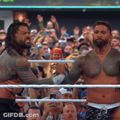 Two Men Wrestling In Front Of A Crowd With A Star On The Bottom Right GIF