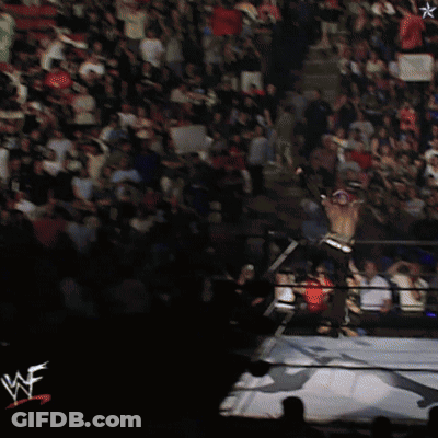 Two Men Wrestling In Front Of Screen With Star GIF