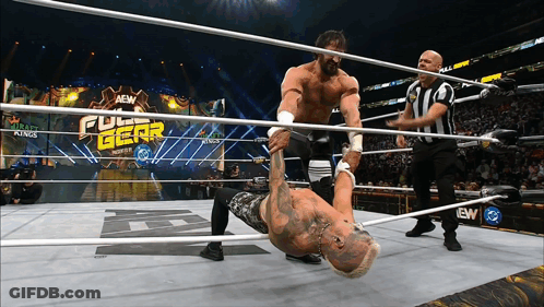Two Men Wrestling In Full Gear Ring GIF