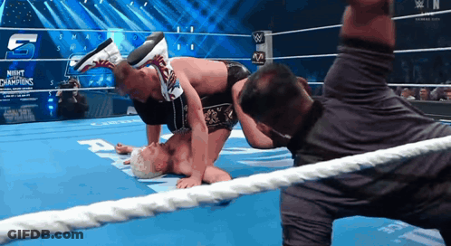 Two Men Wrestling In Night Of The Champions GIF