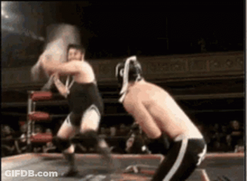 Two Men Wrestling In Ring One With Helmet GIF