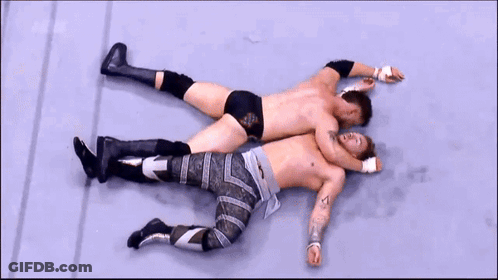 Two Men Wrestling In Ring With AEW Sign GIF