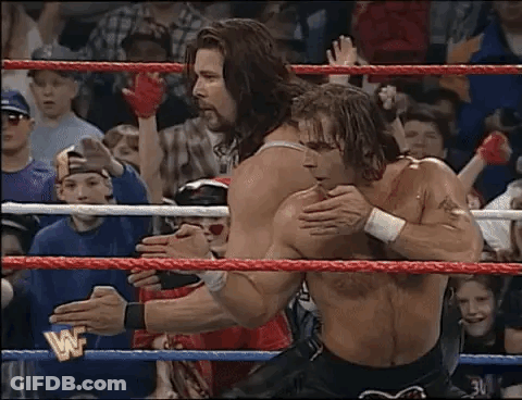 Two Men Wrestling In Ring With Crowd GIF