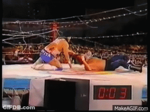 Two Men Wrestling In Ring With Digital Clock GIF