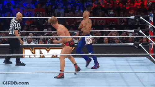 Two Men Wrestling In Ring With NM Sign GIF