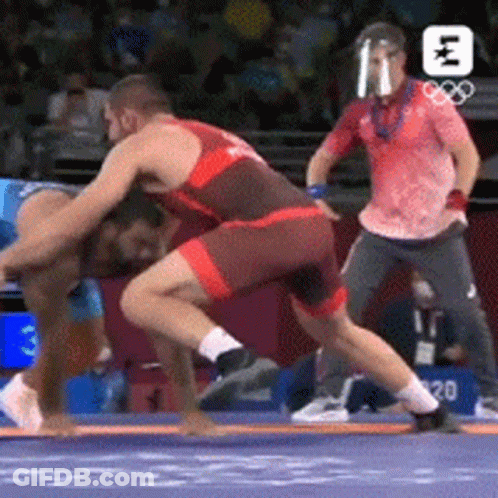 Two Men Wrestling In Ring With Referee GIF