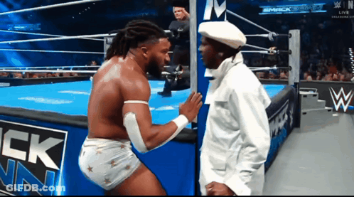 Two Men Wrestling In Ring With Smack Down Sign GIF