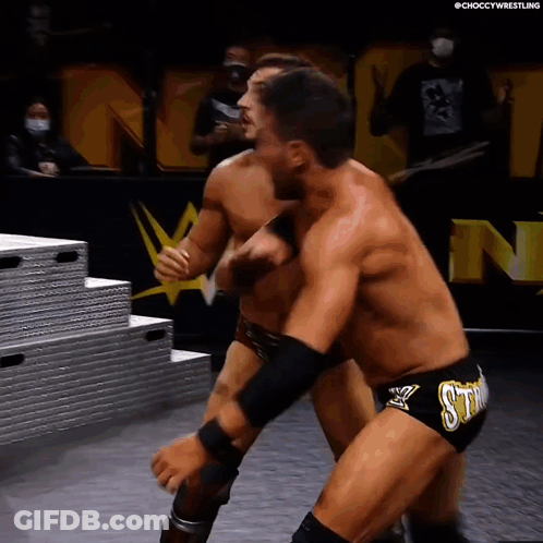 Two Men Wrestling In Ring With Sting Shorts GIF