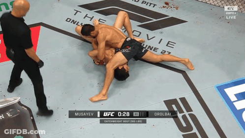 Two Men Wrestling On UFC Ring At 2:28 GIF