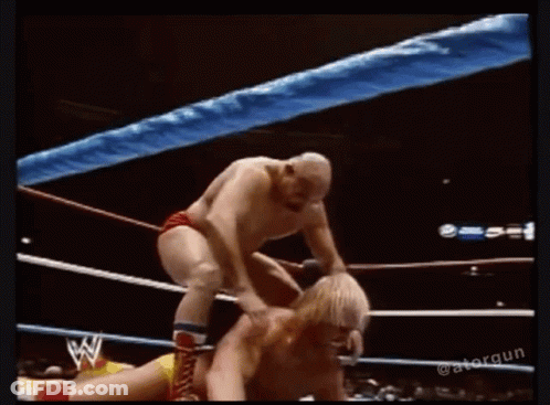 Two Men Wrestling One Holding Other's Head GIF