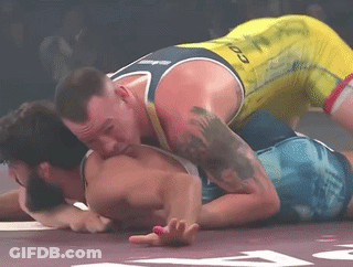 Two Men Wrestling One In Yellow Tank Top With Infinity GIF