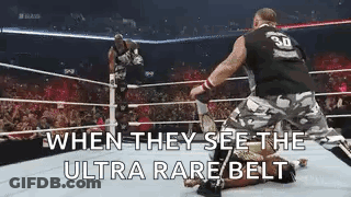 Two Men Wrestling When They See The Ultra Rare Belt GIF