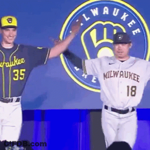 Two Milwaukee Baseball Players Next To Logo GIF