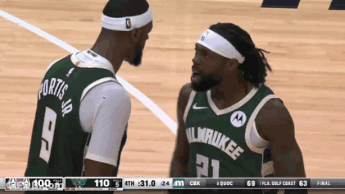 Two Milwaukee Basketball Players Are Talking On The Court GIF