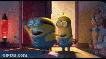 Two Minions Are Dancing In A Room In Front Of A Door . GIF