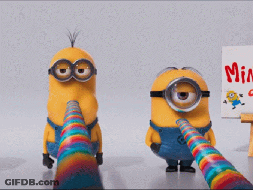 Two Minions Are Standing Next To A Sign That Says Minion GIF