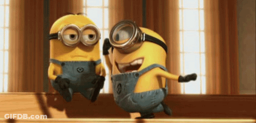 Two Minions In Goggles And Overalls Together GIF