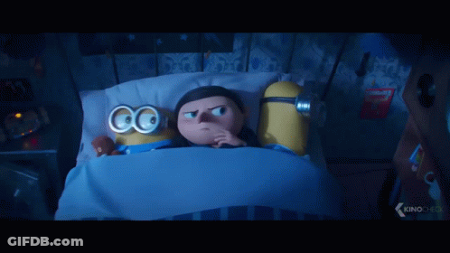 Two Minions Lying In Bed With Goggles GIF