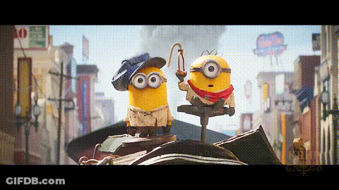Two Minions Standing On City Street GIF