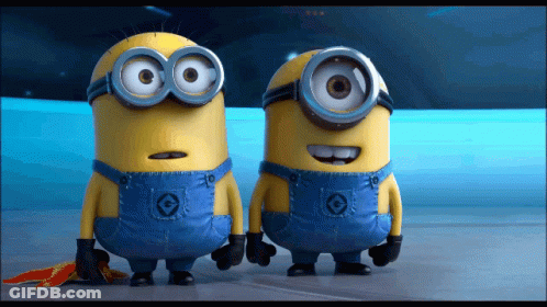Two Minions Standing Together One With C Overalls GIF