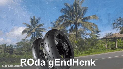 Two Motorcycle Tires On A Road With Roda Gendhenk Written In White GIF